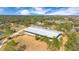Aerial view of equestrian property with large arena, barns, and paddocks at 2140 W State Road 46, Geneva, FL 32732