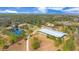 Aerial view of property with pond and equestrian facilities at 2140 W State Road 46, Geneva, FL 32732