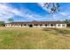 Long barn with multiple stalls, a gabled roof, and a grassy yard at 2140 W State Road 46, Geneva, FL 32732