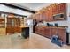 Well-equipped kitchen featuring wood cabinets and granite counters at 2140 W State Road 46, Geneva, FL 32732
