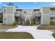 Two-story building with two units, each with its own staircase and small patio at 245 Scottsdale Sq # 245, Winter Park, FL 32792