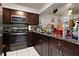 Dark wood cabinets, granite countertops, and stainless steel appliances at 245 Scottsdale Sq # 245, Winter Park, FL 32792