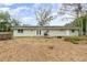 Backyard showcasing a well maintained patio and an in-ground spa, perfect for outdoor gatherings and relaxation at 24908 County Road 561, Astatula, FL 34705