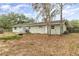 The backyard features lush foliage around the yard, a well-maintained patio, and ample space for outdoor activities at 24908 County Road 561, Astatula, FL 34705