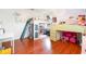 This colorful bedroom features a unique lofted bed, ample storage, and natural light at 24908 County Road 561, Astatula, FL 34705
