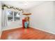 Bright bedroom showcasing wood floors, a ceiling fan, a window with drapes, and natural light at 24908 County Road 561, Astatula, FL 34705