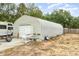 Metal garage exterior with a roll up door in a spacious yard that offers plenty of room for outdoor activities at 24908 County Road 561, Astatula, FL 34705