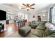 Open-concept living room and kitchen area, featuring hardwood flooring and modern decor at 24908 County Road 561, Astatula, FL 34705