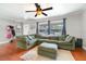 Spacious living room with a large window providing ample natural light and hardwood flooring at 24908 County Road 561, Astatula, FL 34705