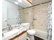 Bathroom featuring a tub, tile surround, toilet, vanity, mirror, and shower with floral curtain at 3208 Oak Lawn Pl # 218, Winter Park, FL 32792