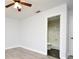 Bathroom with white walls and door, light-colored flooring, and a partially visible toilet and shower at 3208 Oak Lawn Pl # 218, Winter Park, FL 32792