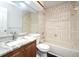 Bathroom featuring a tub, tile surround, toilet, vanity, mirror, and shower with floral curtain at 3208 Oak Lawn Pl # 218, Winter Park, FL 32792