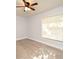 This bedroom features light gray walls, laminate flooring, a window with blinds, and a ceiling fan at 3208 Oak Lawn Pl # 218, Winter Park, FL 32792