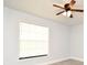 This bedroom has light gray walls, laminate flooring, a window with blinds, and a ceiling fan at 3208 Oak Lawn Pl # 218, Winter Park, FL 32792