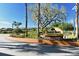 A welcoming Hidden Oaks community sign with lush landscaping and beautiful trees on a sunny day at 3208 Oak Lawn Pl # 218, Winter Park, FL 32792