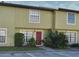 Charming townhome with neutral paint, red door, and manicured landscaping at 3208 Oak Lawn Pl # 218, Winter Park, FL 32792