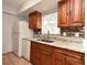 Well-lit kitchen with wooden cabinets, stainless steel sink, and modern appliances at 3208 Oak Lawn Pl # 218, Winter Park, FL 32792