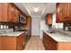 Kitchen boasts granite countertops, stainless appliances and wood cabinets at 3208 Oak Lawn Pl # 218, Winter Park, FL 32792