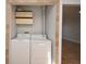 Convenient laundry area with washer, dryer, and overhead storage at 3208 Oak Lawn Pl # 218, Winter Park, FL 32792