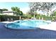 Relaxing community pool with lounge chairs, tables, and well-maintained landscaping at 3208 Oak Lawn Pl # 218, Winter Park, FL 32792