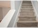 Stylish staircase with wooden steps and white railings at 3208 Oak Lawn Pl # 218, Winter Park, FL 32792