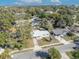 An aerial view showcases this charming single Gathering home with a well-manicured lawn and mature trees at 3309 Drake Dr, Orlando, FL 32810