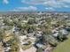 An aerial view showcases homes in a serene neighborhood with mature trees and city skyline in the distance at 3309 Drake Dr, Orlando, FL 32810
