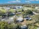 An aerial view of the neighborhood showing nearby school and tree-lined streets under a sunny, partly cloudy sky at 3309 Drake Dr, Orlando, FL 32810