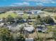 An aerial view of the neighborhood showing nearby school and tree-lined streets under a sunny, partly cloudy sky at 3309 Drake Dr, Orlando, FL 32810