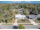 An aerial view showcases this charming single Gathering home with a well-manicured lawn and mature trees at 3309 Drake Dr, Orlando, FL 32810