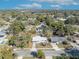 An aerial view showcases this charming single Gathering home with a well-manicured lawn and mature trees at 3309 Drake Dr, Orlando, FL 32810