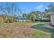 Wide shot of backyard with a small grass area and partial fencing at 3309 Drake Dr, Orlando, FL 32810