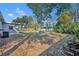 Spacious backyard with partial fence, trees, and room for outdoor activities at 3309 Drake Dr, Orlando, FL 32810