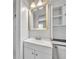 Bathroom with a white vanity, storage, and a shower at 3309 Drake Dr, Orlando, FL 32810