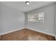 This bedroom features hardwood floors and a window at 3309 Drake Dr, Orlando, FL 32810