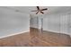 A large bedroom with hardwood floors, ceiling fan and closet doors at 3309 Drake Dr, Orlando, FL 32810