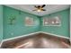 Bright bedroom with hardwood floors, ceiling fan, and dual windows at 3309 Drake Dr, Orlando, FL 32810