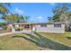 Home exterior showing the front yard, driveway and some trees at 3309 Drake Dr, Orlando, FL 32810