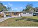 A single story home with a large front yard, carport and brick accents at 3309 Drake Dr, Orlando, FL 32810