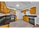 Well-lit kitchen featuring wood cabinets, backsplash, and stainless steel dishwasher at 3309 Drake Dr, Orlando, FL 32810