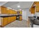 A lovely kitchen with wood cabinets, gray flooring, and modern appliances at 3309 Drake Dr, Orlando, FL 32810