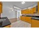 This bright kitchen features wood cabinets and black granite countertops at 3309 Drake Dr, Orlando, FL 32810