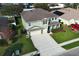 Aerial view of a charming two-story home with a well-manicured lawn and a long concrete driveway at 341 Skyview Pl, Chuluota, FL 32766