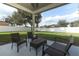 Inviting covered patio area with outdoor furniture, perfect for relaxing in the backyard at 341 Skyview Pl, Chuluota, FL 32766