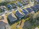 A bird's-eye perspective of homes reveals spacious yards and organized street layouts, highlighting community planning and green spaces at 3608 Mount Hope Loop, Leesburg, FL 34748