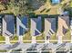 A symmetrical aerial shot of homes displays orderly lawns and driveways, with a focus on architectural uniformity and landscaping at 3608 Mount Hope Loop, Leesburg, FL 34748