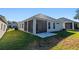 Backyard with an enclosed lanai, a small patio and green grass at 3608 Mount Hope Loop, Leesburg, FL 34748