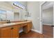 This bathroom is equipped with double sinks, vanity lighting, and wood cabinets at 3608 Mount Hope Loop, Leesburg, FL 34748