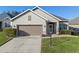 Charming single-story home with a two-car garage, well-maintained landscaping, and neutral-colored stucco exterior at 3608 Mount Hope Loop, Leesburg, FL 34748