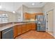 This kitchen is well-lit and is equipped with stainless steel appliances and wood flooring at 3608 Mount Hope Loop, Leesburg, FL 34748